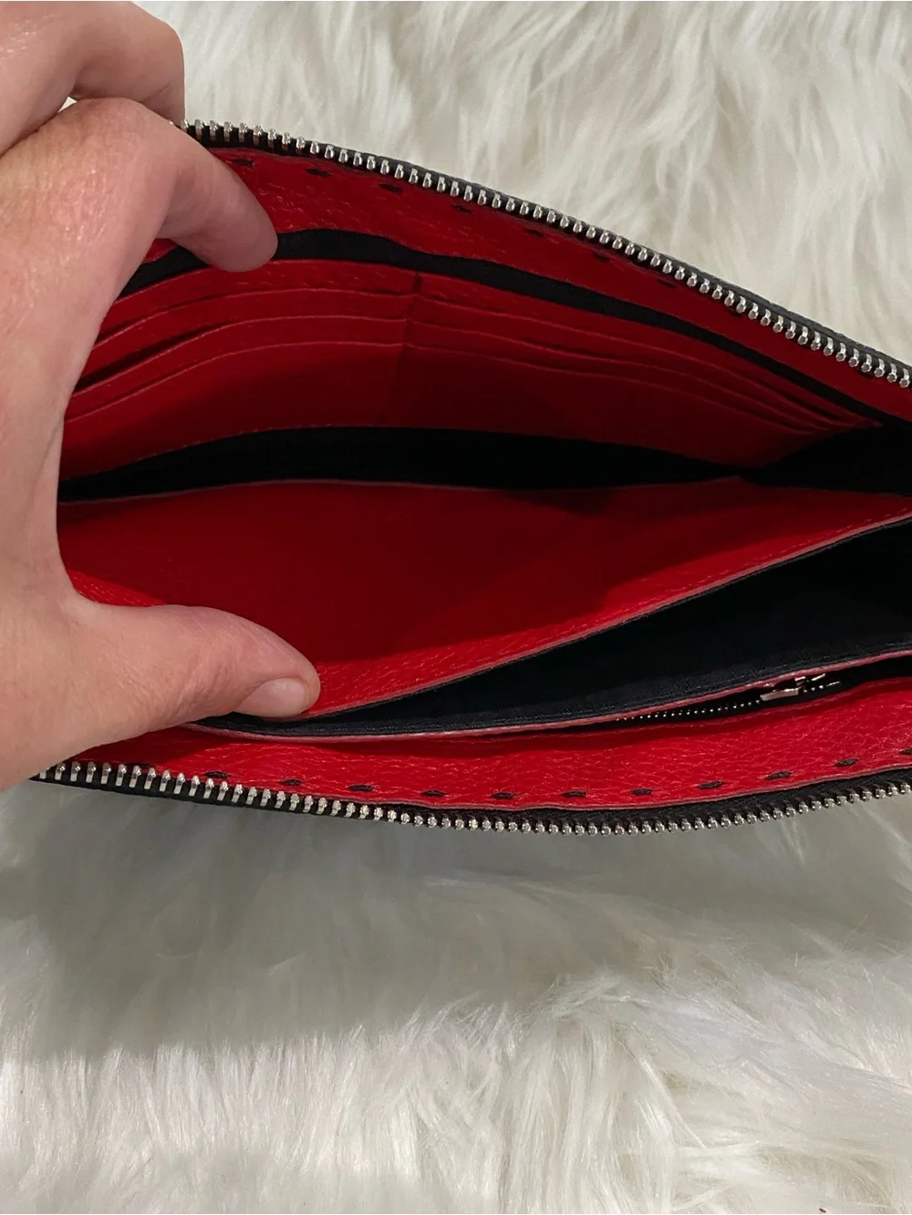 Fendi Selleria flat clutch bag with red stitching and red leather handle
